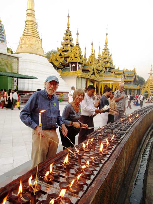 The author and her husband lighting candles in Myanmar. Photo courtesy Fyllis Hockman