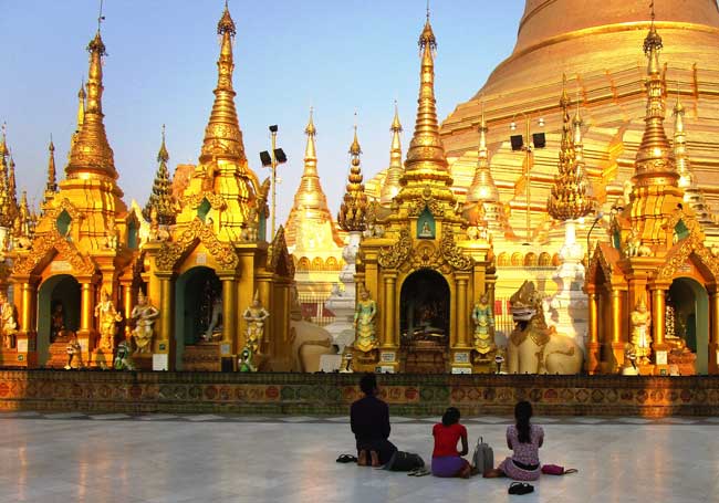 Locals praying at a pagoda in Myanmar. Photo by Victor Block