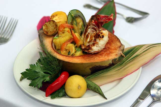 Coconut bowl with curried seafood at Sunset in the Palms Resort. Photo by Sunset in the Palms. 