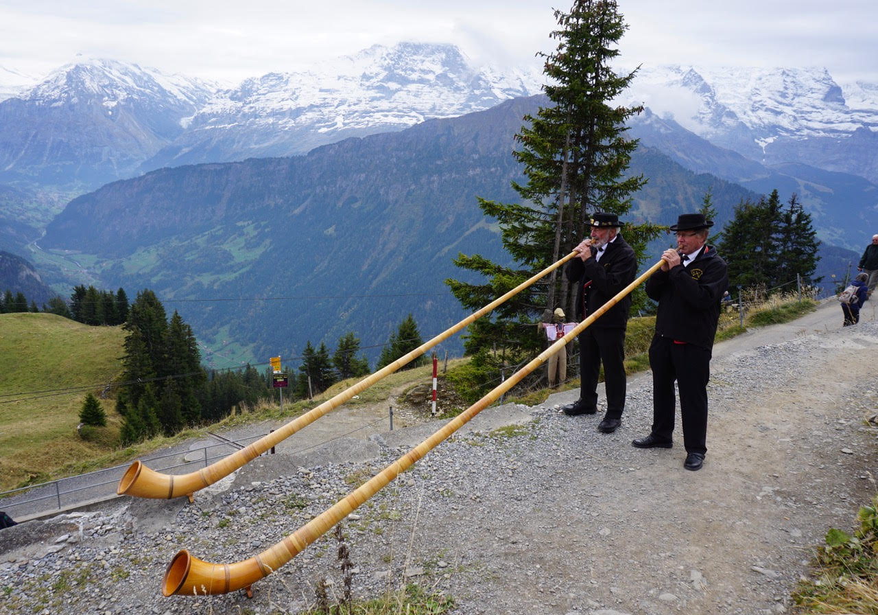 On our hiking adventure in the Swiss Alps, we encounter alphorn players in Schynige Platte