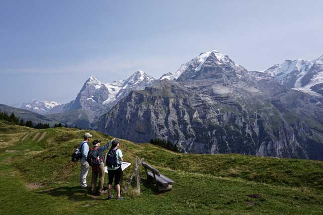 Hiking in Switzerland, and identifying Eiger, Monch and Jungfrau peaks above Murren.