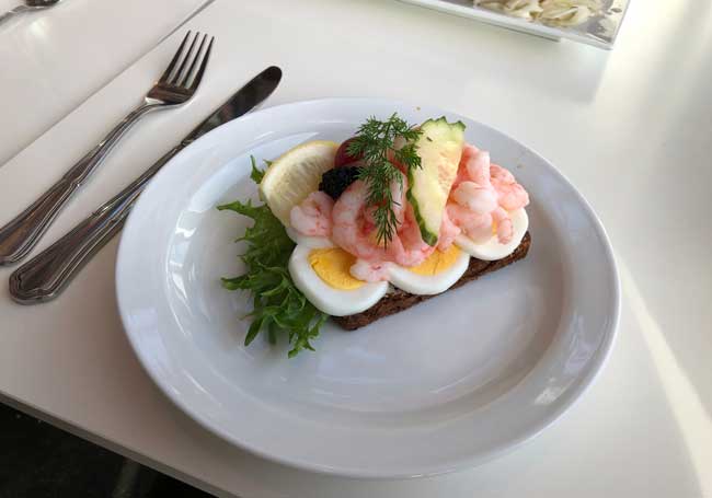 A plate of smorrebrod at the Culture Yard at Helsingor. Photo by Birds dressed for winter at a store in Humlebaek. Photo by Susmita Sengupta