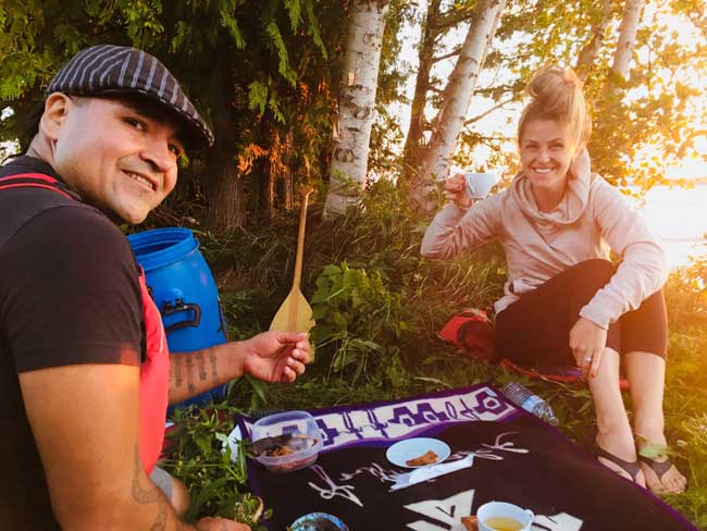 The author learns more about First Nations culture during the Great Spirit Circle Trail with Falcon, a tour guide and cultural coordinator. Photo courtesy Carri Wilbanks