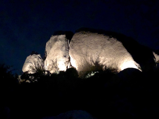 Specific rock formation are lit up at night. Photo by Claudia Carbone