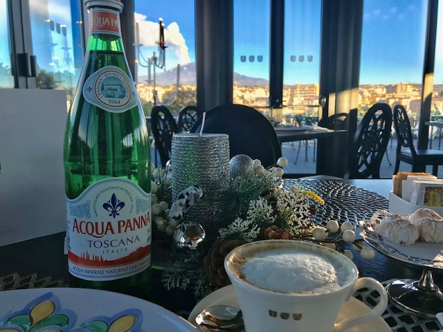 Breakfast with sparkling water and cappuccino.