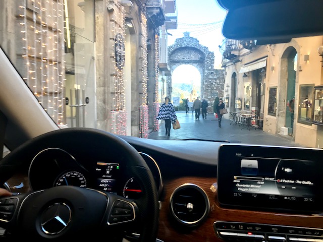 Driving Mercedez-Benz on little road.