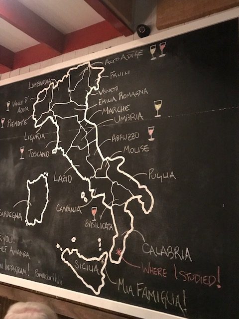 A chalkboard at Pomodori in Hilton Head with a map of Italy, displaying where the flavors come from in Italy.