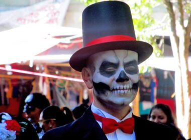 A man playing the part of a "catrin" donned a top hat and tuxedo at Day of the Dead in Oaxaca, Mexico. Photo by Carol L. Bowman