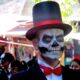 A man playing the part of a "catrin" donned a top hat and tuxedo at Day of the Dead in Oaxaca, Mexico. Photo by Carol L. Bowman
