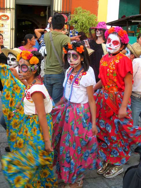 Parade participants called comparsas wear calavera faces and included children, teens, adults, and elders. Photo by Carol L. Bowman