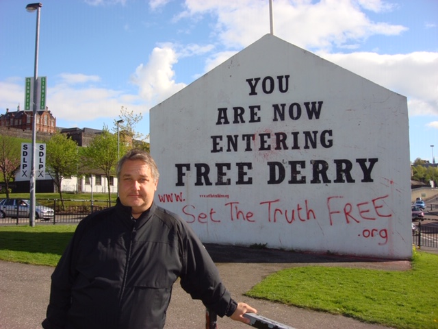 MPS standing in front of sign saying, "You are now entering Free Derry"