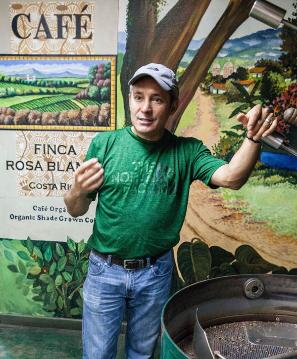 Manolo Munoz, coffee plantation guide at the Finca Rosa Blanca inn, 20 minutes north of San Jose, explains the coffee bean sorter during a plantation tour. ©Steve Haggerty