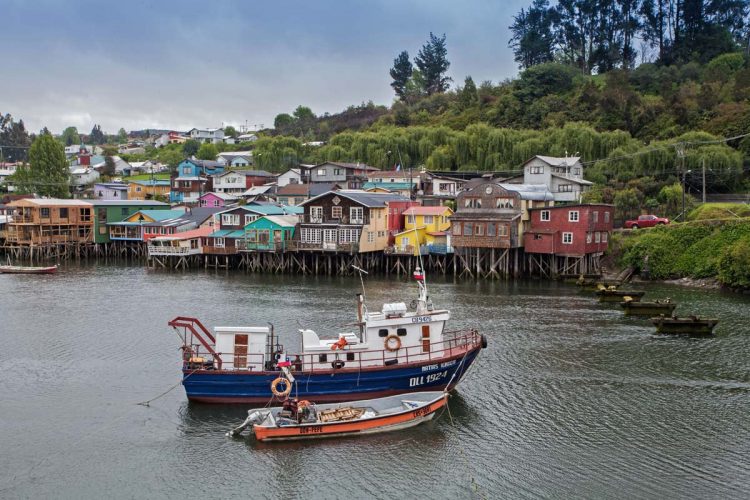 ”Palafitos”, wooden stilt houses, some centuries old, line the west shore of Fiordo de Castro bay, Chiloé, Chile. ©Steve Haggerty/ColorWorld