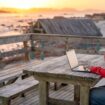 Digital nomad sitting outdoors on the beach with a laptop. Photo by Oscar Gutierrez Zozulia, iStock