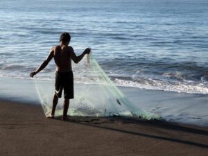 Fisherman on the black sands of Monterrico
