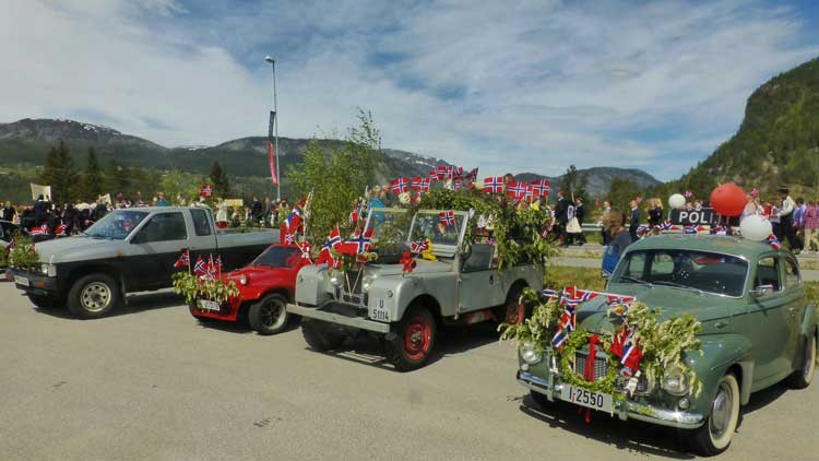 The car on the right is a retired old police car, now dressed up for the parade in Valle, Norway. 