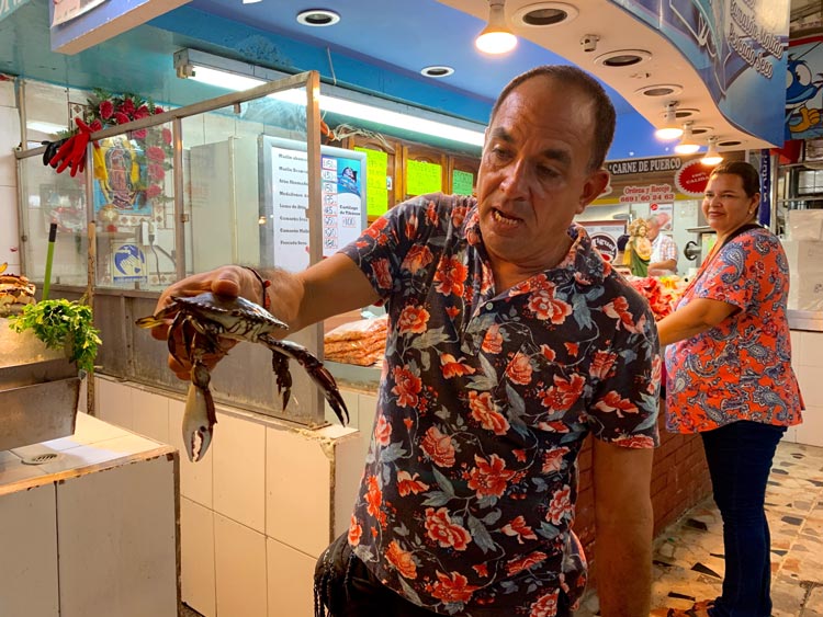 Gustavo and a local crab in Mazatlan, Mexico