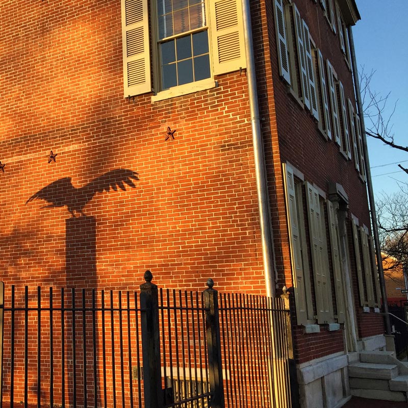 PHILADELPHIA: Edgar Allan Poe National Historic Site has the shadow of raven on the walls in late afternoon soon. Poe spent his most productive and happy years in the house immediately behind this, which is today a museum. Photo by Rich Grant