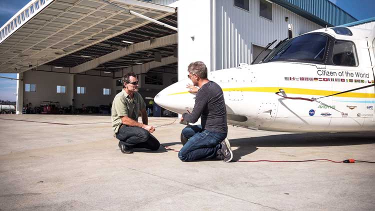 Robert with Dr. Dimitri Deheyn installing the experiment on the plane. 