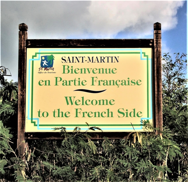 Only modest signs mark the border between the French and Dutch sides of t. Martin/Sint Maarten. Photo by Victor Block