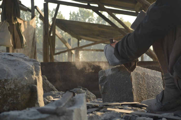 The blow of a stone mason's strike.