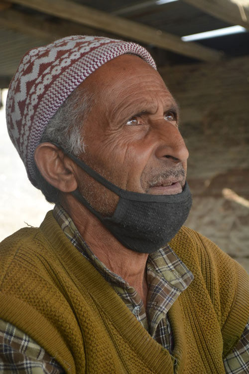 A man's eyes shining as he discusses stone carving.