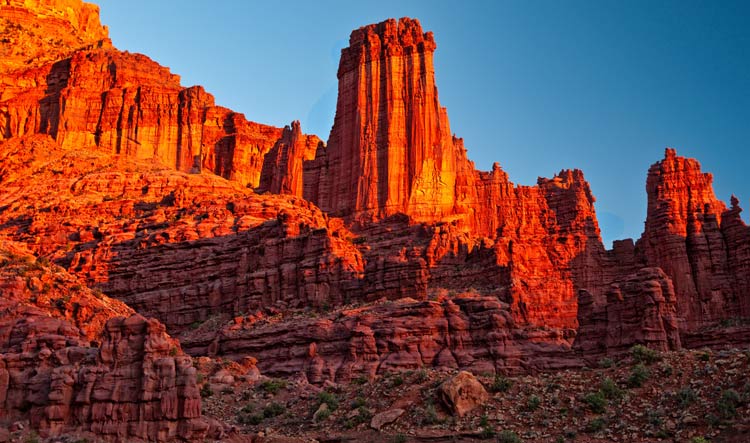 Red rock cliffs glow in the sunset along the Colorado river in Moab, Utah.