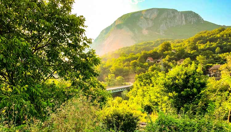 A train riding out to the mountains beyond of Belgrade.