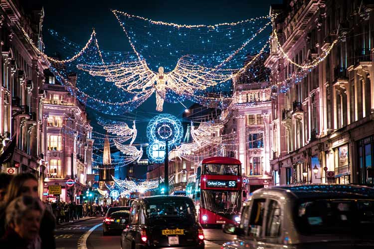 The bustling Regent Street filled with people lights up the night during the holidays.