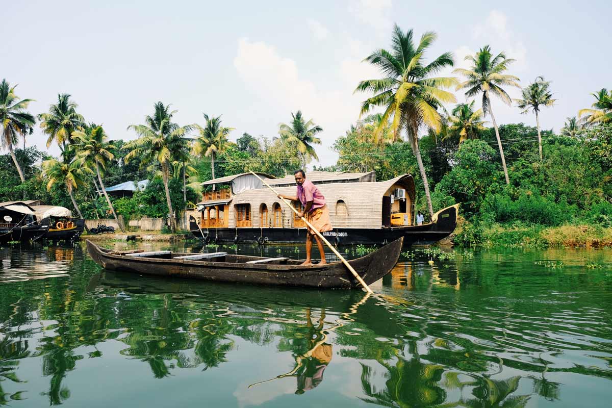 A man boating on the backwaters of the Kerala river in India