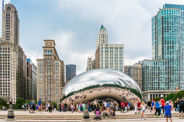 Crowds gather at on of Chicago's main attractions, The Bean, which reflects the whole city.