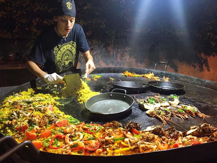 Cooking with a huge hot table at local cafe.