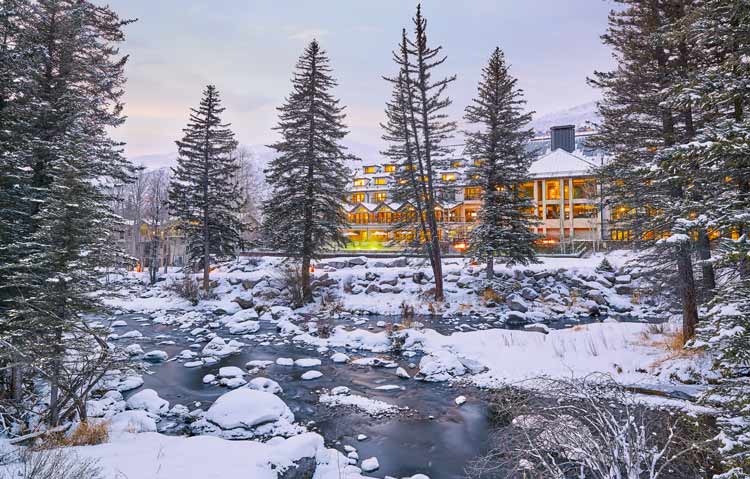 View of Grand Hyatt Hotel from the snowy Gore Creek. 