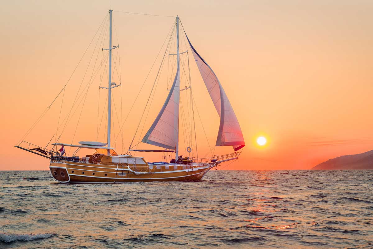 A gulet boat cruises through the Mediterranean