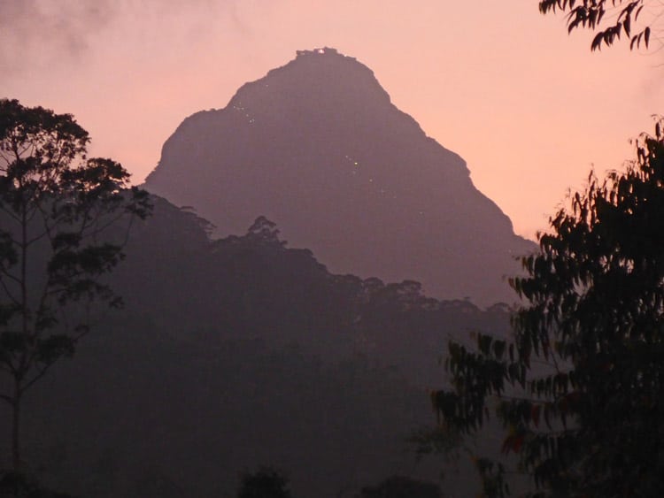 Adam's Peak looms above Dalhousie village in a purple haze at dusk.