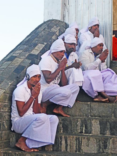 Buddhist monks praying on the summit of Adam's Peak.