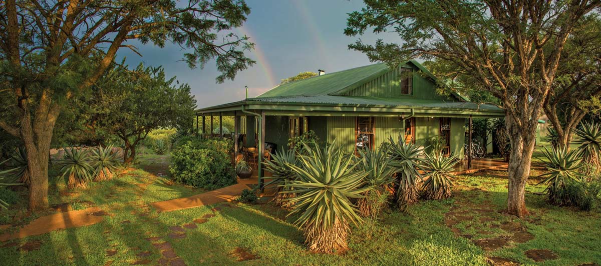 The front of the lodge with a rainbow behind it.
