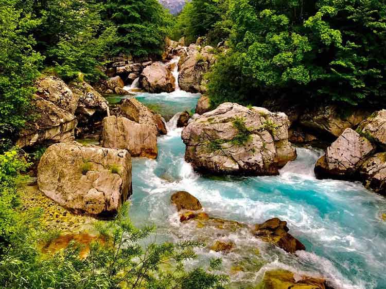 Capturing the bright blue Varbona River rushing past the boulders