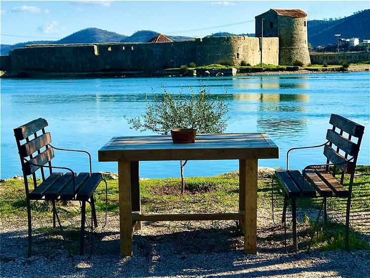 Relax at a table by the river.