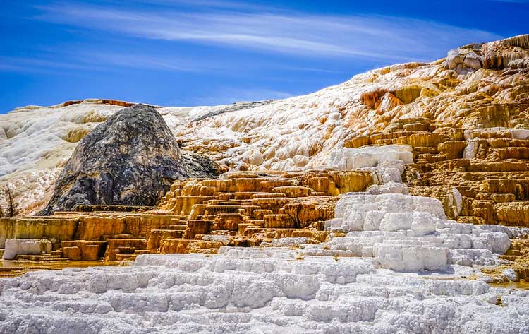 Mammoth Hot Springs lightly covered in snow over some rocks