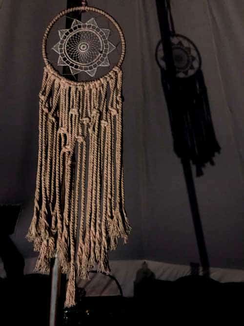 A dreamcatcher hangs from a pole