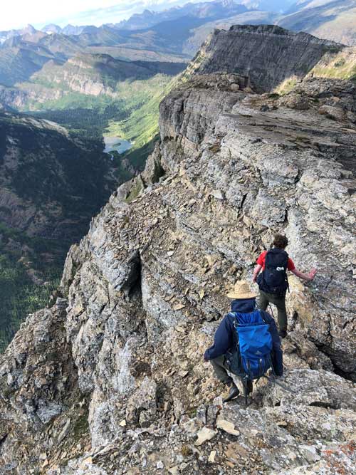 Two people on the side of a mountain.