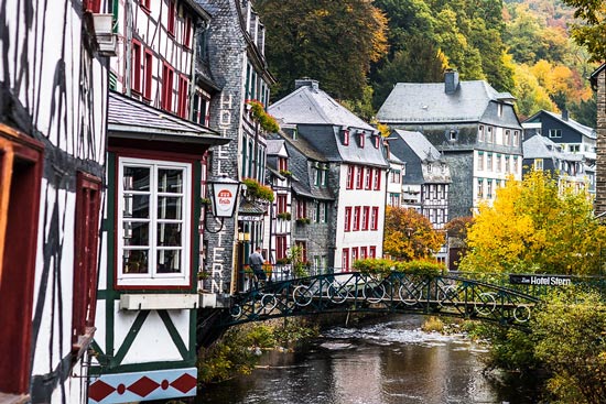 Bridge decorated over river through town of Monschau