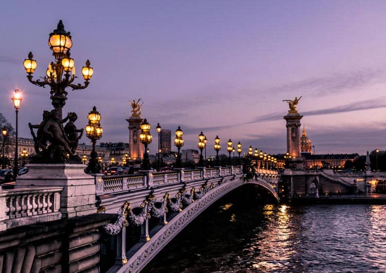 Wander above the Seine at dusk in Paris