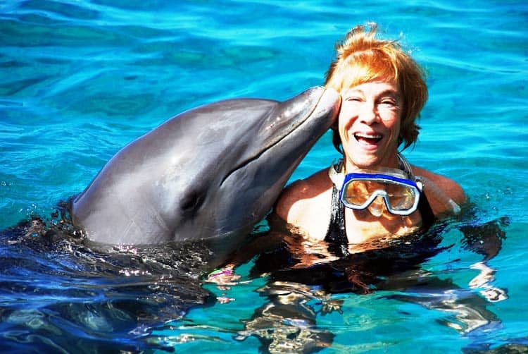 A dolphin kiss is well worth waiting for after free swim at the Dolphin Academy   Photo by Victor Block