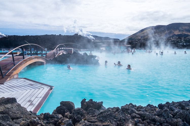 People enjoying the Blue Lagoon steamy waters