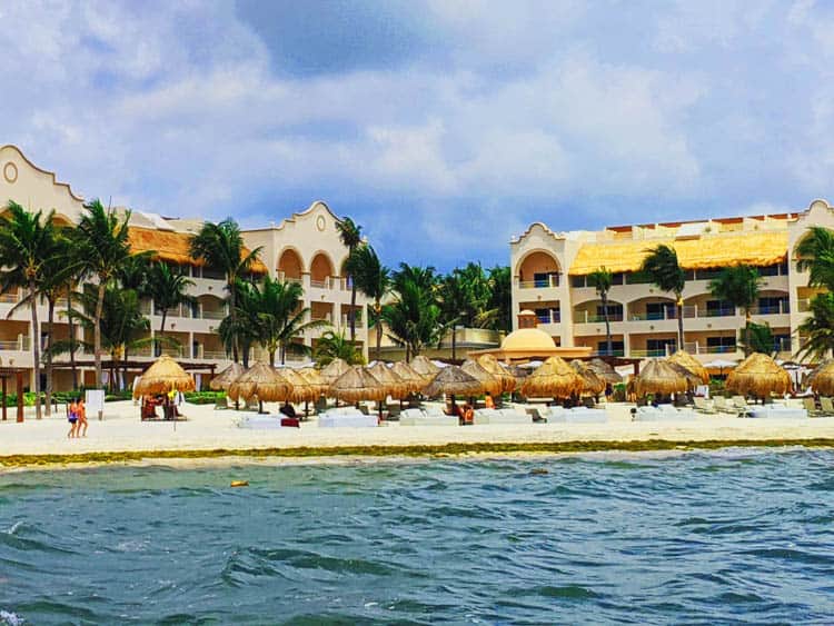 Riviera Maya Loungers beneath palm thatched canopies 