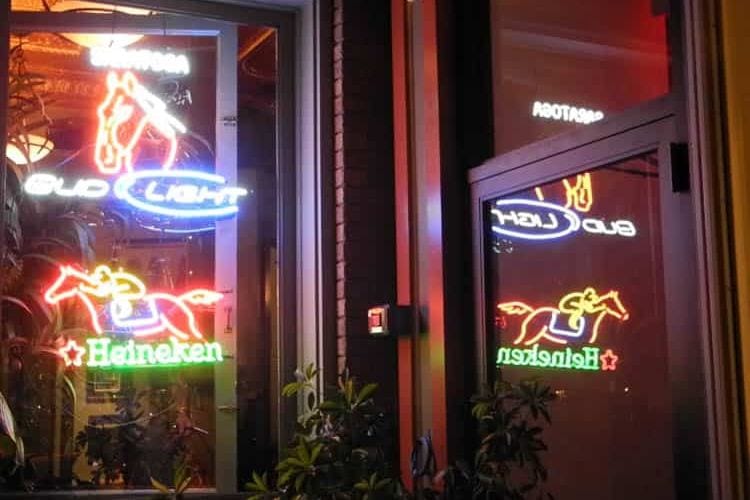 Restaurant windows lit with horse and jockey lights