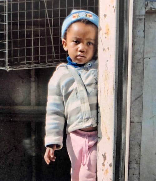 African adventure Driving through Maseru and a child watches us from her front door