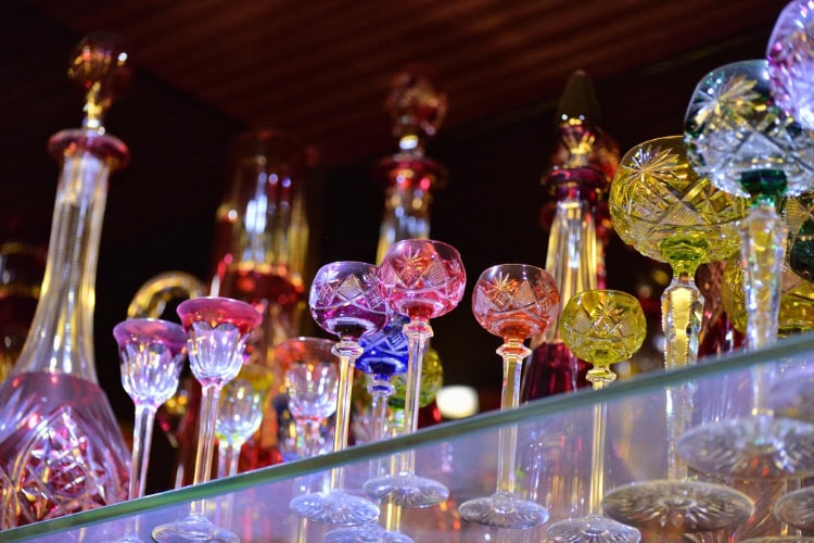 Colored cut crystal glasses and decanters in Czechia. Photo by Ebony Hack via iStock
